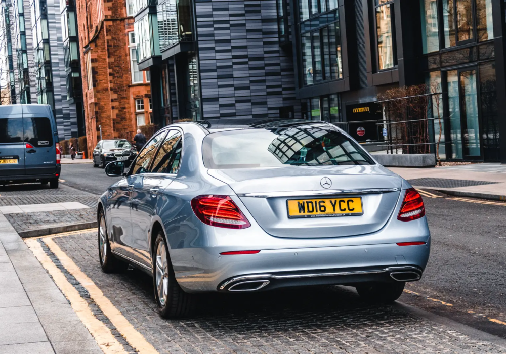 Executive Airport Transfer - Mercedes-Benz E-Class in Scotland Silver Mercedes-Benz E-Class ready for executive airport transfers in the modern streets of Scotland.