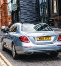 Silver Mercedes-Benz E-Class ready for executive airport transfers in the modern streets of Scotland.