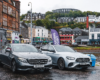 Silver Mercedes vehicles ready for St Andrews transfer in Scottish town.