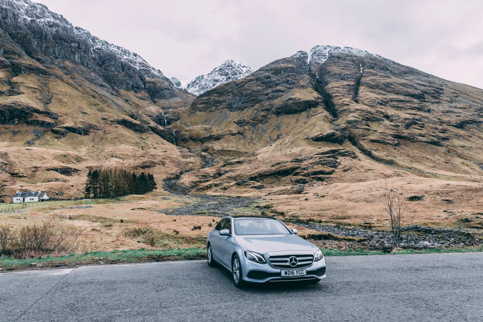 From City to Scenic Highlands Silver Mercedes-Benz ready for St Andrews executive transfer with Scottish highlands in the background.