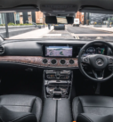 Interior of a Mercedes-Benz E-Class with navigation system, providing comfortable executive transfers in Scotland.