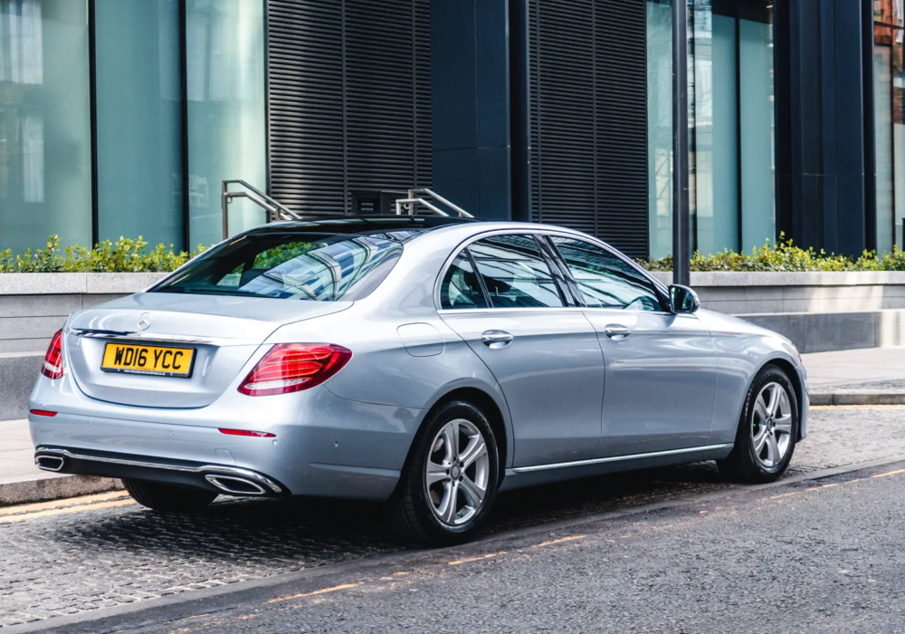Executive Airport Transfer - Silver Mercedes-Benz E-Class Silver Mercedes-Benz E-Class ready for hotel transfers, parked on a Scottish city street.