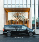 Executive hotel transfer service with a black Mercedes V-Class.