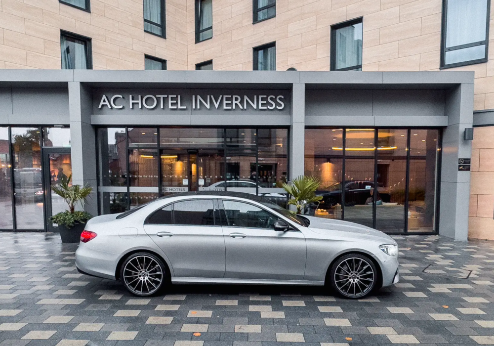 Mercedes E-Class positioned for hotel transfer at AC Hotel Inverness.