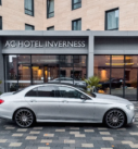 Mercedes E-Class positioned for hotel transfer at AC Hotel Inverness.
