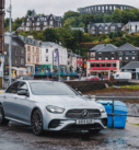 Mercedes E-Class ready for an executive transfer in Oban with the town's charming scene in the backdrop.