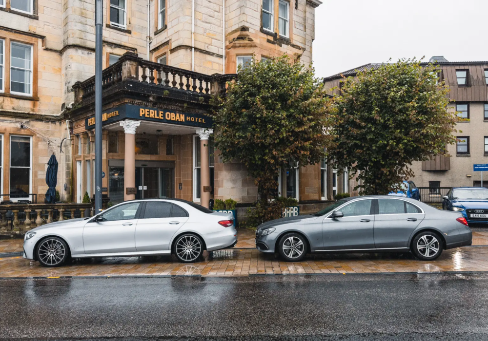 Mercedes-Benz vehicles poised for executive hotel transfers at the Perle Oban Hotel entrance.