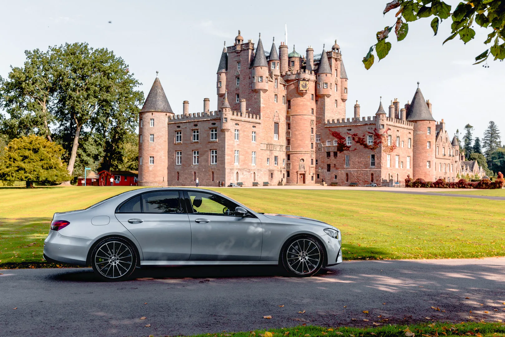 Ready for Your Private Tour: Glamis Castle to St Andrews Mercedes-Benz E-Class ready for a scenic transfer, with Glamis Castle in the backdrop, on a private tour to St Andrews.