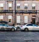 Grey and silver Mercedes-Benz cars ready for city tours, parked in historic Edinburgh.