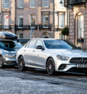 Grey Mercedes with rooftop box and silver Mercedes, side by side, ready for city-to-city travel and airport pickups in Scotland.